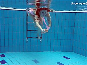 redhead Simonna flashing her assets underwater